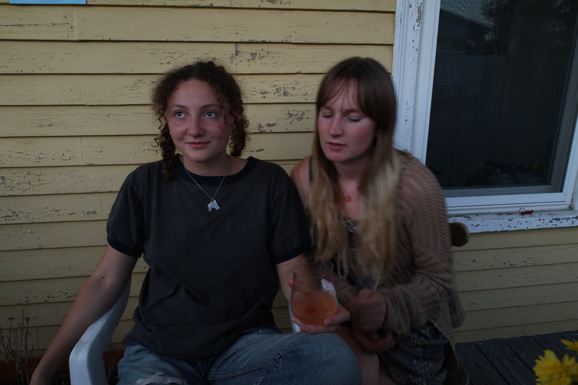 Audrey with a friend on a porch